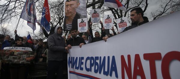 Protesters holding a banner that reads: Serbia is not NATO during a protest against NATO in downtown Belgrade, Serbia, Saturday, Feb. 20, 2016 - Sputnik Moldova-România