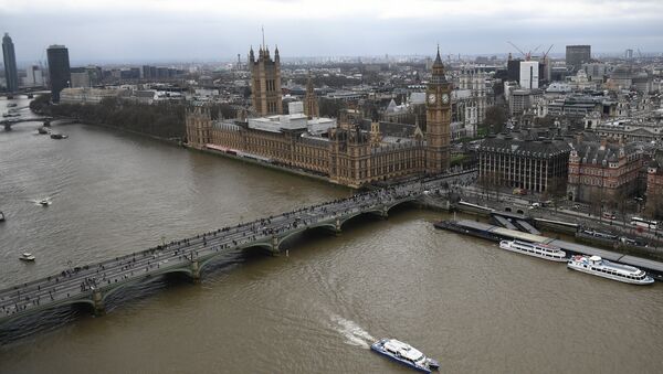The Palace of Westminster, comprising the House of Commons and the House of Lords, wchich together make up the Houses of Parliament, are pictured on the banks of the River Thames alongside Westminster Bridge in central London on March 29, 2017 - Sputnik Moldova-România