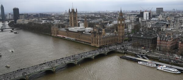 The Palace of Westminster, comprising the House of Commons and the House of Lords, wchich together make up the Houses of Parliament, are pictured on the banks of the River Thames alongside Westminster Bridge in central London on March 29, 2017 - Sputnik Moldova-România