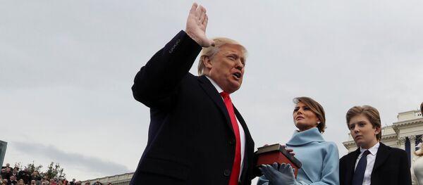 U.S. President Donald Trump takes the oath of office as his wife Melania holds the bible and his children Barron, Ivanka, Eric and Tiffany watch as U.S. Supreme Court Chief Justice John Roberts (R) administers the oath during inauguration ceremonies swearing in Trump as the 45th president of the United States on the West front of the U.S. Capitol in Washington, DC, U.S., January 20, 2017 - Sputnik Moldova-România