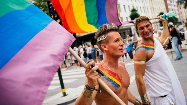 Participants carry a rainbow flag during the Gay Pride Parade on August 2, 2014, in Stockholm - Sputnik Moldova-România