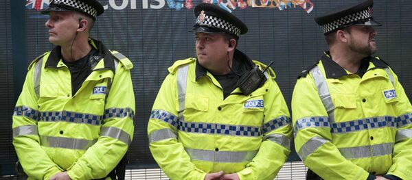 Police stand guard near a defaced sign during a demonstration outside the Conservative Party Conference in Manchester, Britain October 6, 2015. - Sputnik Moldova