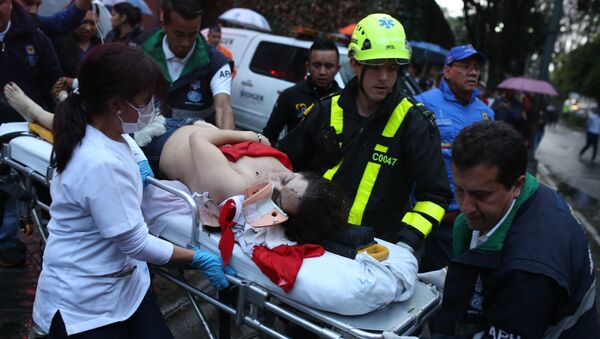 A woman is evacuated on a gurney after an explosion at the Centro Andino shopping center in Bogota, Colombia, Saturday, June 17, 2017. - Sputnik Moldova