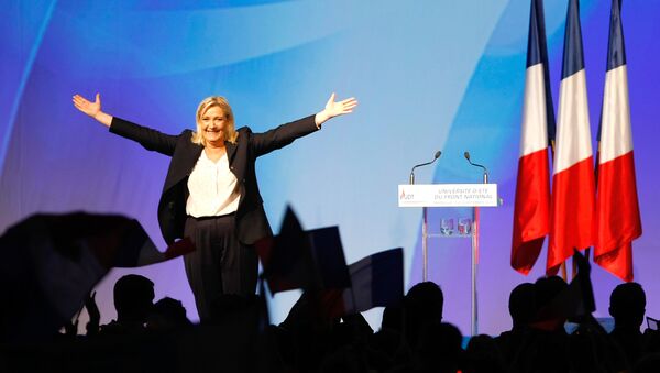 France’s far-right National Front president Marine Le Pen, center, surrounded by members, waves to supporters after her speech during their meeting in Marseille, southern France, Saturday, Sept. 6, 2015. - Sputnik Moldova