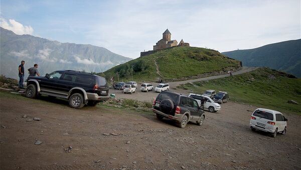Автомобили у церкви Святой Троицы на горе у села Гергети, Казбегский район - Sputnik Молдова