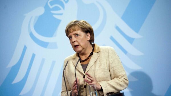 German Chancellor Angela Merkel  in front of Germany's heraldic eagle - Sputnik Moldova