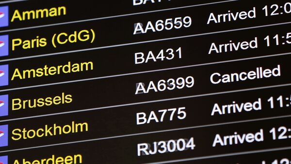 An arrivals board displays a cancelled flight from Brussels with an American Airlines code at Terminal 5, Heathrow Airport in London, Britain March 22, 2016 - Sputnik Moldova-România