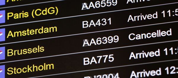 An arrivals board displays a cancelled flight from Brussels with an American Airlines code at Terminal 5, Heathrow Airport in London, Britain March 22, 2016 - Sputnik Moldova-România