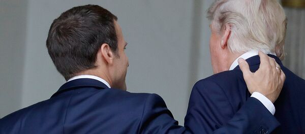 French President Emmanuel Macron (L) shares a laugh with US President Donald Trump as they arrive at the Elysee Palace on July 13, 2017 in Paris during Trump's 24-hour trip that coincides with France's national day and the 100th anniversary of US involvement in World War I. Donald Trump arrived in Paris for a presidential visit filled with Bastille Day pomp and which the White House hopes will offer respite from rolling scandal backing home. - Sputnik Moldova-România