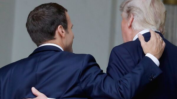 French President Emmanuel Macron (L) shares a laugh with US President Donald Trump as they arrive at the Elysee Palace on July 13, 2017 in Paris during Trump's 24-hour trip that coincides with France's national day and the 100th anniversary of US involvement in World War I. Donald Trump arrived in Paris for a presidential visit filled with Bastille Day pomp and which the White House hopes will offer respite from rolling scandal backing home. - Sputnik Moldova-România