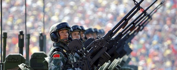 Soldiers of the People's Liberation Army (PLA) of China arrive on their armoured vehicles at Tiananmen Square during the military parade marking the 70th anniversary of the end of World War Two, in Beijing, China, September 3, 2015. - Sputnik Moldova-România