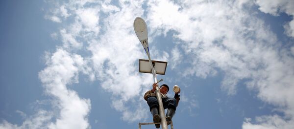 Мужчина ремонтирует уличный фонарь Мужчина ремонтирует уличный фонарь - Sputnik Молдова