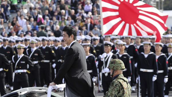 Japanese Prime Minister Shinzo Abe, center standing, reviews members of Japan Self-Defense Forces (SDF) during the Self-Defense Forces Day at Asaka Base, north of Tokyo, Sunday, Oct. 23, 2016. - Sputnik Moldova-România