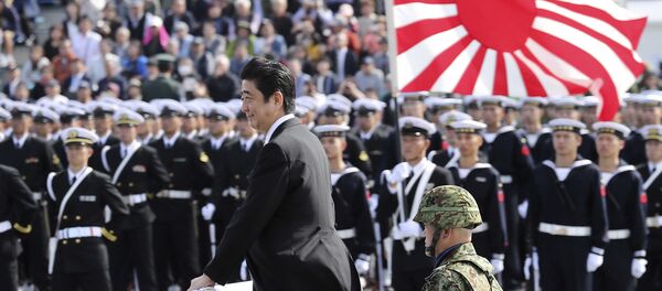 Japanese Prime Minister Shinzo Abe, center standing, reviews members of Japan Self-Defense Forces (SDF) during the Self-Defense Forces Day at Asaka Base, north of Tokyo, Sunday, Oct. 23, 2016. Japanese Prime Minister Shinzo Abe, center standing, reviews members of Japan Self-Defense Forces (SDF) during the Self-Defense Forces Day at Asaka Base, north of Tokyo, Sunday, Oct. 23, 2016. - Sputnik Moldova-România
