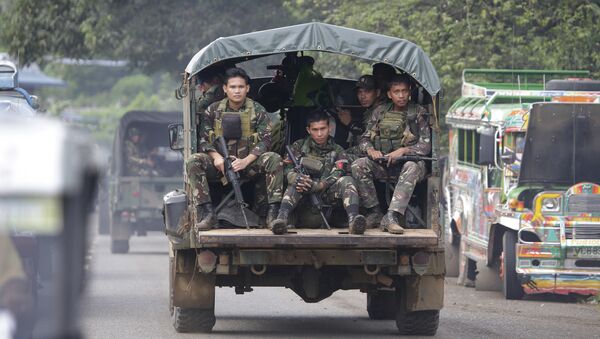 In this June 9, 2017, photo, soldiers ride a military vehicle on the outskirts of Marawi city, southern Philippines. The Philippine military says 13 marines have been killed in fierce fighting with Muslim militants who have laid siege to southern Marawi city. - Sputnik Moldova-România