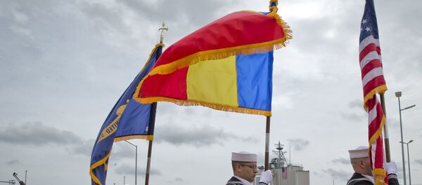 US Navy flag bearers, backdropped by the radar building of a missile defense base, walk in Deveselu, during an opening ceremony attended by U.S., NATO and Romanian officials at a base, originally established by the Soviet Union, in Deveselu, Southern Romania, Thursday, May 12, 2016. - Sputnik Moldova-România