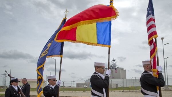  US Navy flag bearers, backdropped by the radar building of a missile defense base, walk in Deveselu, during an opening ceremony attended by U.S., NATO and Romanian officials at a base, originally established by the Soviet Union, in Deveselu, Southern Romania, Thursday, May 12, 2016. - Sputnik Moldova