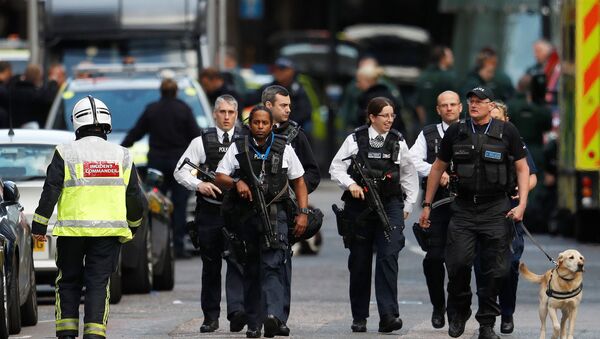 Armed police officers walk outside Borough Market after a terror attack in London, Britain. - Sputnik Moldova-România