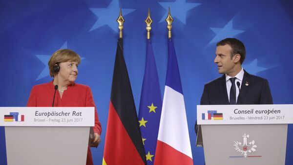 German Chancellor Angela Merkel, left, and French President Emmanuel Macron prepare to address the media at an EU summit in Brussels on Friday, June 23, 2017.  - Sputnik Moldova-România