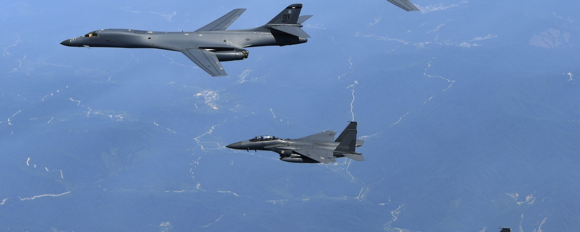 In this June 20, 2017 file photo provided by South Korean Defense Ministry, U.S. Air Force B-1B bombers, top, and second from top, and South Korean fighter jets F-15K fly over the Korean Peninsula, South Korea - Sputnik Moldova-România, 1920, 14.12.2021