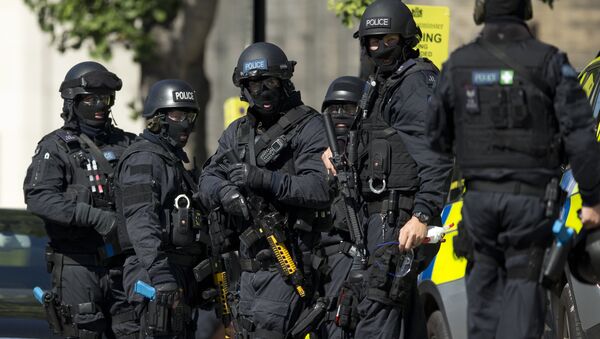 Near the start of a training exercise for London's emergency services, armed police officers stand near the disused Aldwych underground train station in London, Tuesday, June 30, 2015 - Sputnik Moldova-România