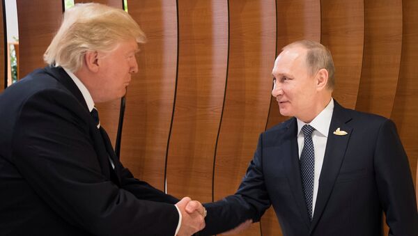 U.S. President Donald Trump and Russia's President Vladimir Putin shake hands during the G20 Summit in Hamburg, Germany in this still image taken from video, July 7, 2017 - Sputnik Молдова