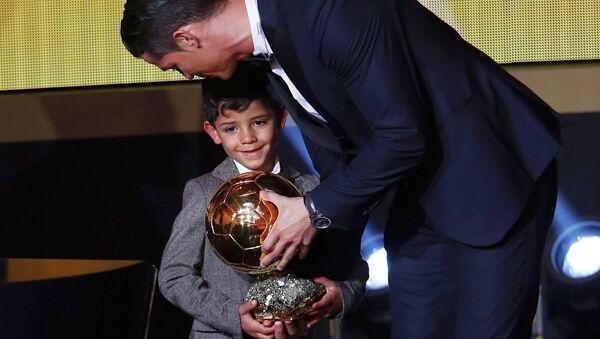 Real Madrid's Cristiano Ronaldo of Portugal, stands with his son Cristiano Ronaldo Jr, after winning the FIFA Ballon d'Or 2014 during the soccer awards ceremony at the Kongresshaus in Zurich January 12, 2015 - Sputnik Moldova-România