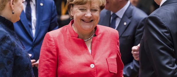 German Chancellor Angela Merkel, center, smiles as she attends a round table meeting at an EU Summit in Brussels on Friday, June 23, 2017. - Sputnik Moldova-România