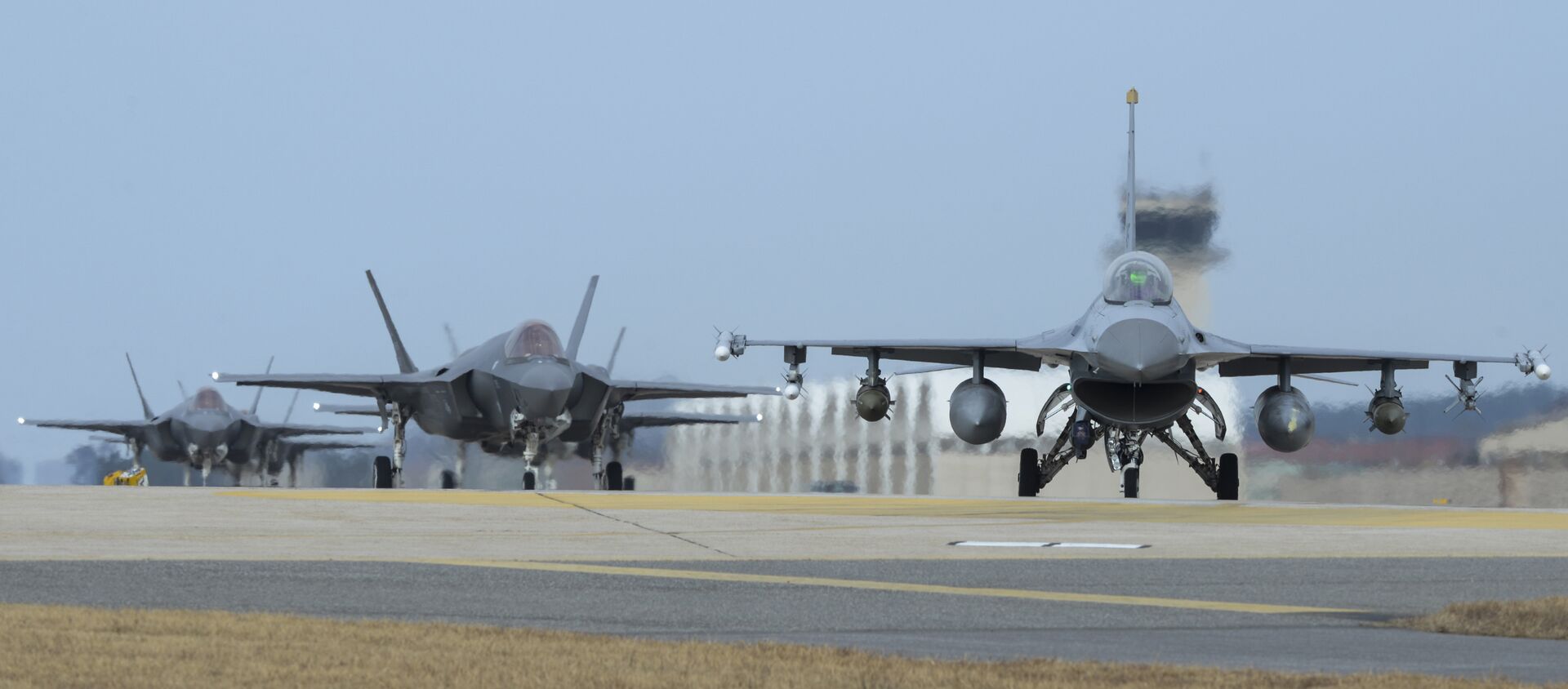 U.S. Air Force F-16 Fighting Falcon, right, and F-35A Lightning IIs assigned to the 34th Expeditionary Fighter Squadron Hill Air Force Base, Utah, taxi toward the end of the runway during the exercise VIGILANT ACE 18 at Kunsan Air Base, South Korea - Sputnik Moldova-România, 1920, 13.07.2021