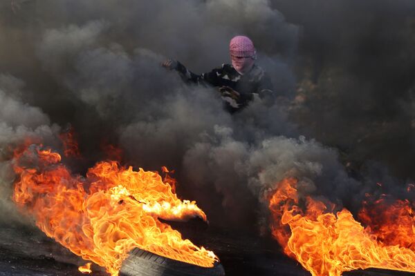 Протестующий во время столкновений на границе Палестины и Израиля в районе Рамаллы - Sputnik Молдова
