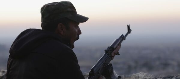 In this Friday, Nov. 13, 2015, file photo, a Kurdish fighter, known as a peshmerga, yawns as he stands guard on the frontline in Sinjar, Iraq - Sputnik Moldova-România