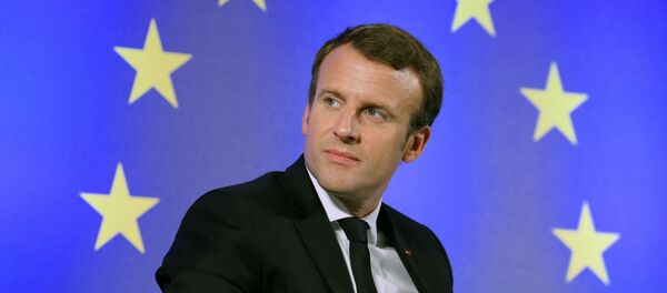 French President Emmanuel Macron looks on as he sits in front of a flag of the European Union during an open debate on Europe on October 10, 2017 at the Goethe University in Frankfurt am Main, western Germany - Sputnik Moldova-România