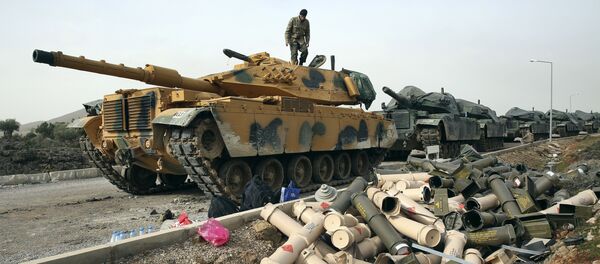 Turkish Army soldiers prepare their tanks next to empty shells at a staging area in the outskirts of the village of Sugedigi, Turkey, on the border with Syria, Monday, Jan. 22, 2018 - Sputnik Moldova-România