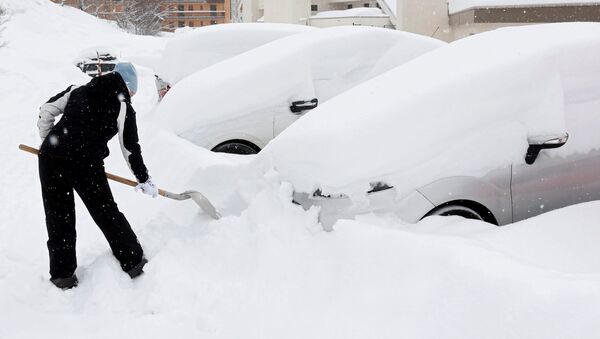 Женщина убирает снег возле своей машины - Sputnik Молдова
