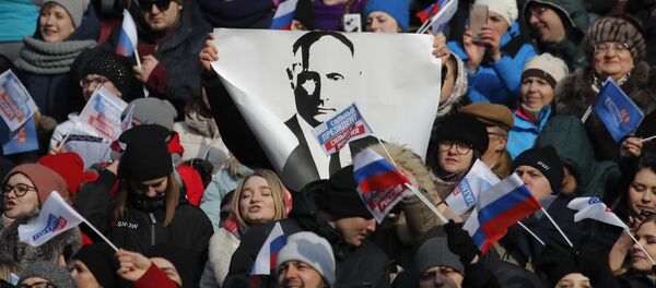 People take part in a rally to support Russian President Vladimir Putin in the upcoming presidential election at Luzhniki Stadium in Moscow, Russia March 3, 2018 - Sputnik Moldova-România