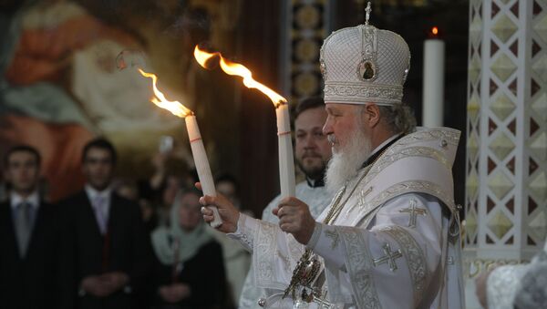 Patriarch Kirill of Moscow and All Russia handed the Holy Fire delivered from Jerusalem to all those thousands of faithful gathered at Moscow's Christ the Savior Cathedral on the Easter Night - Sputnik Moldova-România