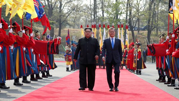South Korean President Moon Jae-in walks with North Korean leader Kim Jong Un at the truce village of Panmunjom inside the demilitarized zone separating the two Koreas, South Korea, April 27, 2018 - Sputnik Moldova-România