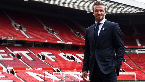 Former Manchester United and England footballer David Beckham poses on the pitch at Old Trafford in Manchester, north west England on October 6, 2015 ahead of a charity football match in aid of UNICEF - Sputnik Moldova-România