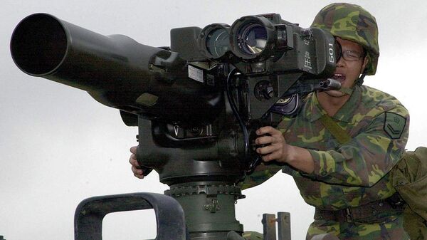 A military soldier operates a TOW anti-tank missile launcher. File photo - Sputnik Moldova