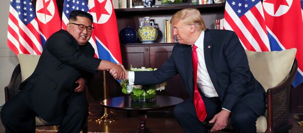 U.S. President Donald Trump shakes hands with North Korea's leader Kim Jong Un before their bilateral meeting at the Capella Hotel on Sentosa island in Singapore June 12, 2018. - Sputnik Moldova-România