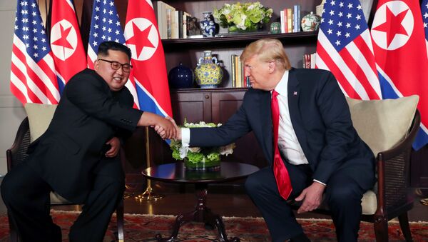 U.S. President Donald Trump shakes hands with North Korea's leader Kim Jong Un before their bilateral meeting at the Capella Hotel on Sentosa island in Singapore June 12, 2018. - Sputnik Moldova