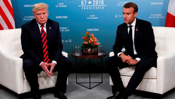U.S. President Donald Trump and France's President Emmanuel Macron sit side by side during a bilateral meeting at the G7 Summit in in Charlevoix, Quebec, Canada, June 8, 2018. - Sputnik Moldova-România