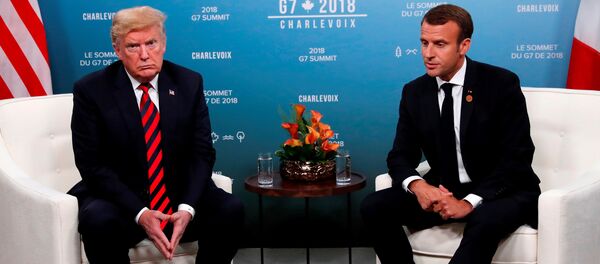 U.S. President Donald Trump and France's President Emmanuel Macron sit side by side during a bilateral meeting at the G7 Summit in in Charlevoix, Quebec, Canada, June 8, 2018. - Sputnik Moldova-România