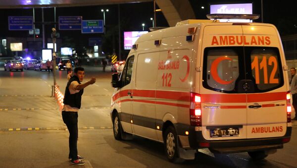 A policeman gestures in front of an ambulance at Istanbul Ataturk airport, Turkey, following a blast June 28, 2016. - Sputnik Moldova-România