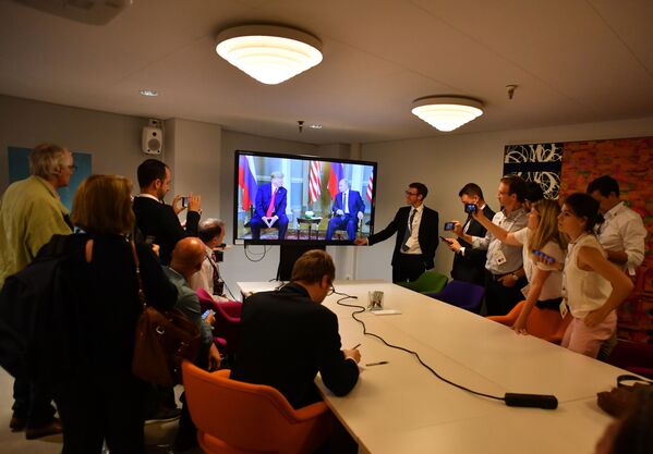 Журналисты смотрят трансляцию встречи президента РФ Владимира Путина и президента США Дональда Трампа в Хельсинки - Sputnik Молдова