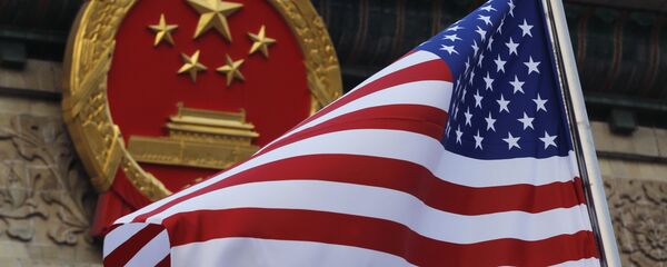 FILE - In this Nov. 9, 2017 file photo, an American flag is flown next to the Chinese national emblem during a welcome ceremony for visiting U.S. President Donald Trump outside the Great Hall of the People in Beijing - Sputnik Moldova-România
