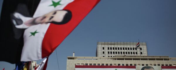 Portrait of President Bashar al-Assad on the Bank of Syria building in Damascus. - Sputnik Moldova