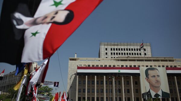 Portrait of President Bashar al-Assad on the Bank of Syria building in Damascus. - Sputnik Moldova-România