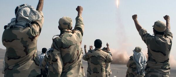 In this photo released by the Islamic Republic News Agency (IRNA), members of the Iranian Revolutionary Guard celebrate after launching a missile during their maneuver in an undisclosed location in Iran (File) - Sputnik Moldova