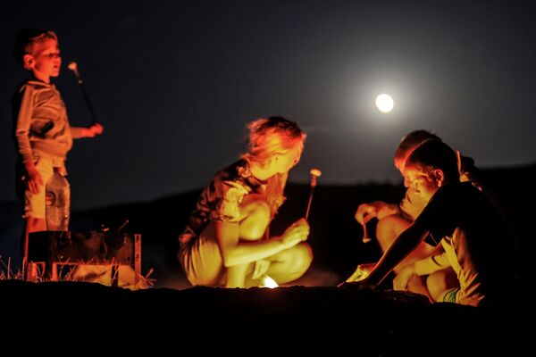 Туристы во время полного лунного затмения над мысом Меганом в Крыму - Sputnik Молдова